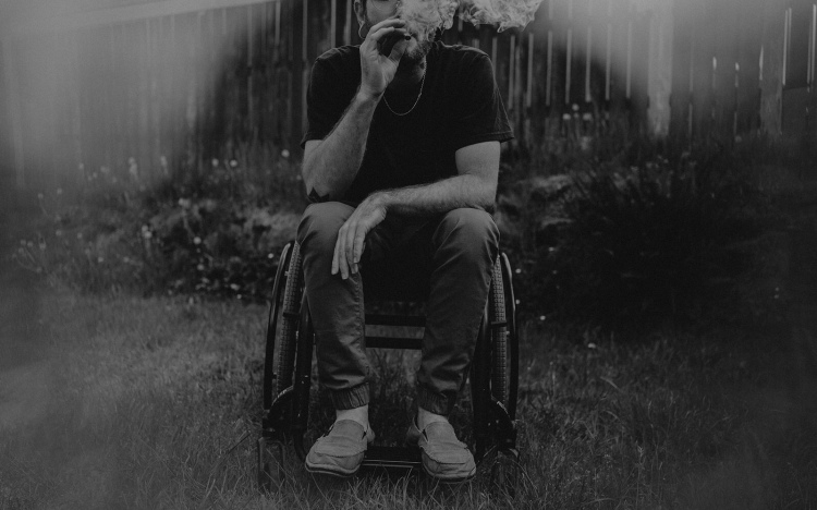 disabled man in wheelchair smoking cannabis for multiple sclerosis in the PNW.